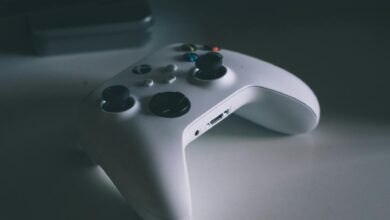 A detailed shot of a white gaming controller on a desk surface, perfect for tech and gaming themes.