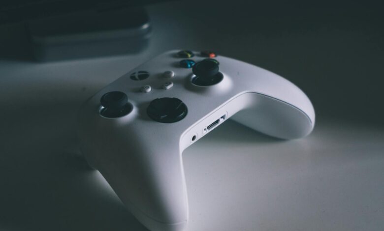 A detailed shot of a white gaming controller on a desk surface, perfect for tech and gaming themes.