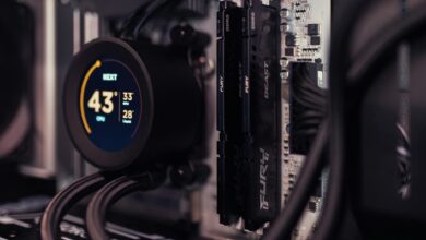 Detailed view of a gaming PC's interior featuring RAM and a digital CPU cooler display.