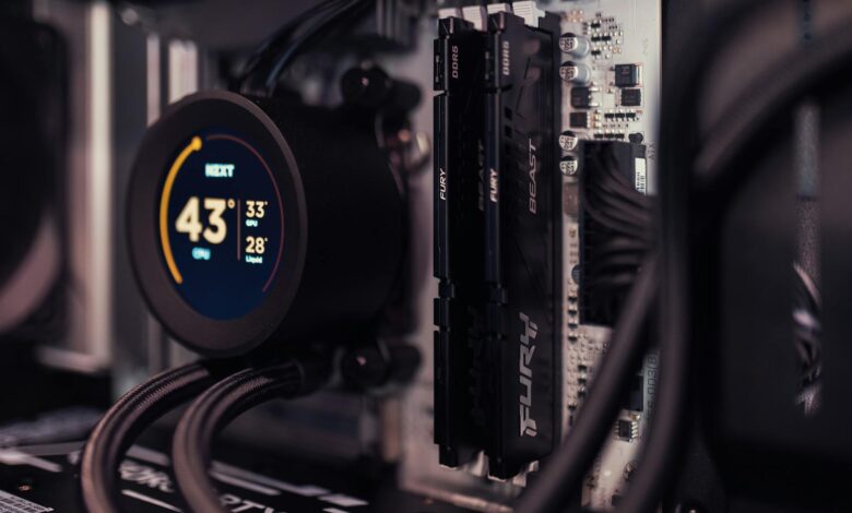 Detailed view of a gaming PC's interior featuring RAM and a digital CPU cooler display.