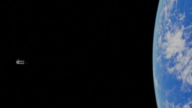 A stunning view of Earth with a distant satellite in space.