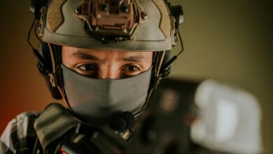 Close-up of a masked soldier in tactical gear with a focused expression.