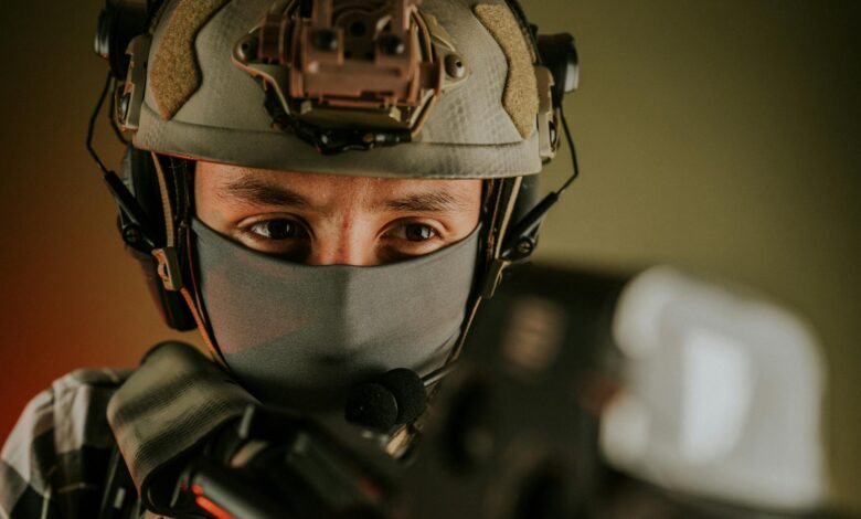 Close-up of a masked soldier in tactical gear with a focused expression.