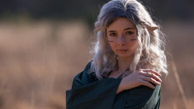 A captivating elf cosplay portrait outdoors with fantasy makeup and ears.