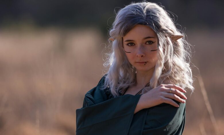 A captivating elf cosplay portrait outdoors with fantasy makeup and ears.