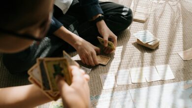 Kids engaged in an entertaining card game inside, with sunlight casting patterns on the floor.