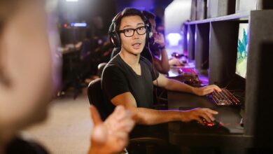 Adult men engaged in competitive video gaming at a modern arcade setting.