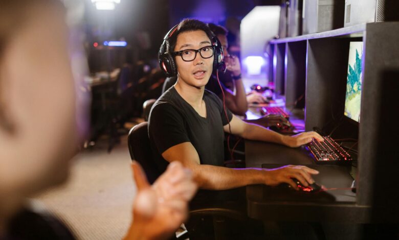 Adult men engaged in competitive video gaming at a modern arcade setting.