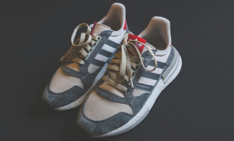Close-up of Adidas sneakers with laces, ideal for running and fashion-forward footwear.