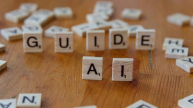 Scrabble letters spelling 'GUIDE' and 'AI' on a wooden surface, suggesting direction and technology.