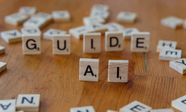 Scrabble letters spelling 'GUIDE' and 'AI' on a wooden surface, suggesting direction and technology.