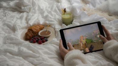 Enjoy a cozy morning in bed with a croissant, berries, matcha latte, and a tablet game.