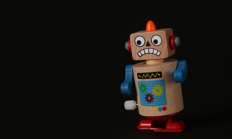 A vibrant wooden toy robot stands on a dark surface, showcasing vivid colors and playful design.