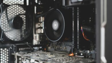 Detailed view of internal computer hardware showcasing cooling fan, RAM, and circuitry.