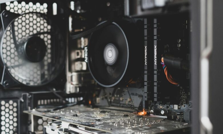Detailed view of internal computer hardware showcasing cooling fan, RAM, and circuitry.