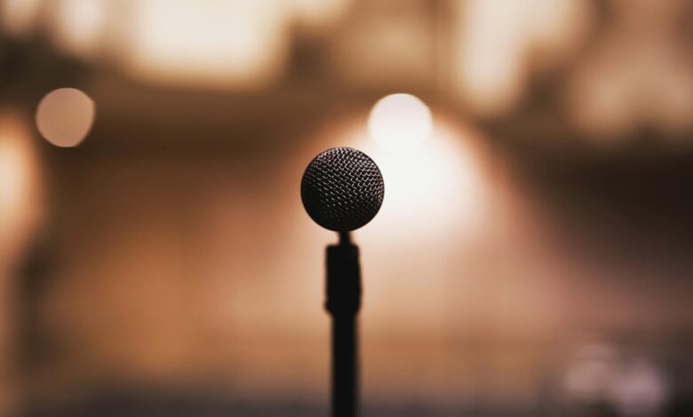 Microphone on stand with blurred background, ideal for music or speech themes.