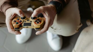 A person playing video games with a vintage-style controller indoors.