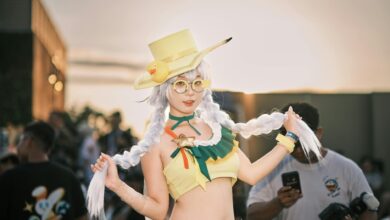 Vibrant cosplay character featuring a woman in a yellow costume at an outdoor event.