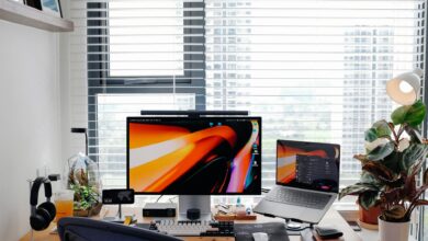 Stylish home office setup featuring a laptop, monitor, and desk accessories.