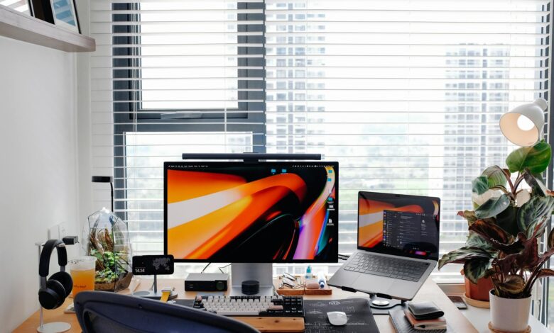 Stylish home office setup featuring a laptop, monitor, and desk accessories.