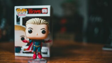 Small bright figure of toy character placed on timber table on blurred background