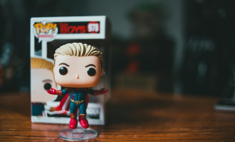 Small bright figure of toy character placed on timber table on blurred background