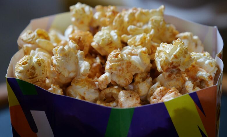 Close-up of crunchy popcorn in a vibrant box, perfect for snack time.