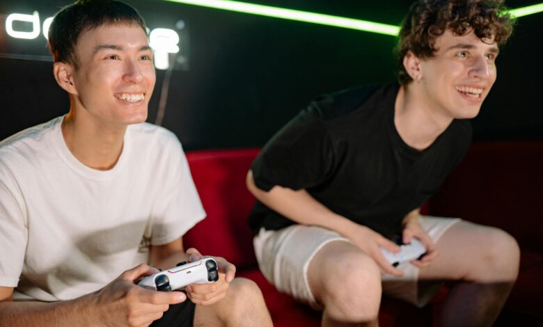 Two friends having fun playing video games indoors, captured in a lively and engaging moment.
