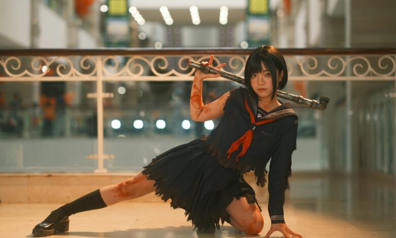 Cosplayer in dynamic pose with weapon in a modern indoor setting, showcasing intricate costume details.
