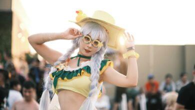 Cosplay enthusiast in colorful costume posing at an outdoor event.