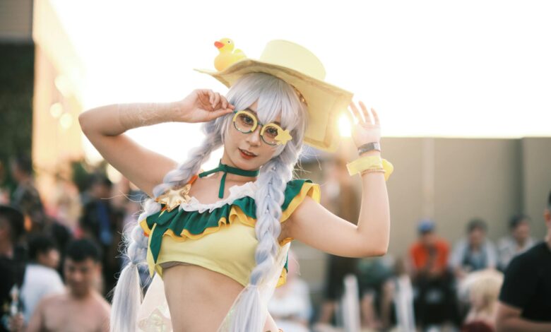Cosplay enthusiast in colorful costume posing at an outdoor event.