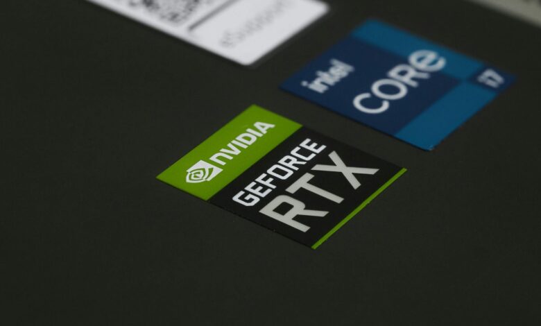 Close-up of NVIDIA GeForce RTX and Intel Core i7 stickers on a laptop surface, showcasing modern technology.