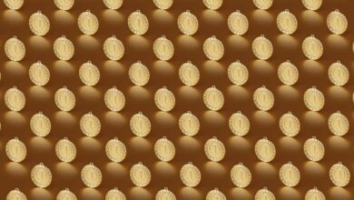 Multiple gold medals arranged in a repeating pattern on a brown backdrop.