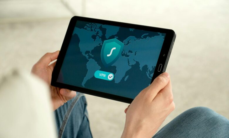 Person holding tablet with VPN connection screen for secure internet browsing.