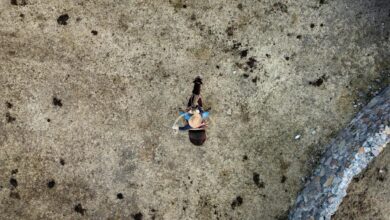Drone shot of a horseback rider wearing a hat in rural Mexico.