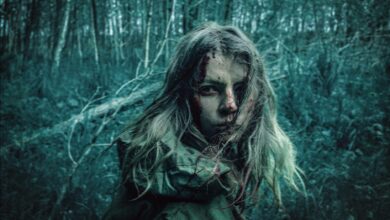 A dramatic portrait of a distressed woman in a dark, eerie forest setting.