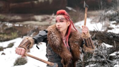 Viking woman in winter armor holding axes, ready for battle; fierce and determined.