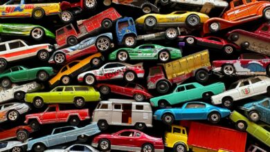 An organized assortment of miniature toy cars displayed in a vibrant and colorful arrangement.