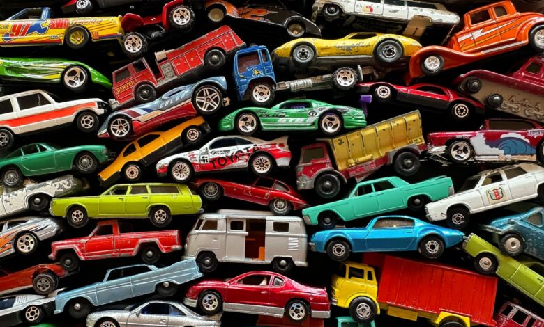 An organized assortment of miniature toy cars displayed in a vibrant and colorful arrangement.