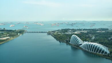 Stunning aerial shot of Singapore's Marina Bay with iconic architecture and ocean harbor.