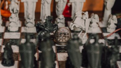 Detailed close-up of a medieval-themed chess set with ornate pieces on a chessboard.
