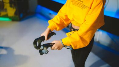 Person engaging in virtual reality gaming indoors with controllers.