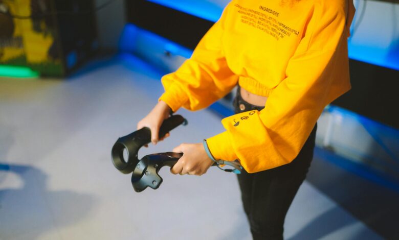 Person engaging in virtual reality gaming indoors with controllers.