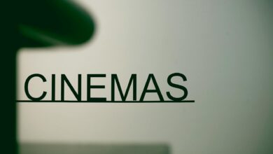 Minimalist cinema sign on pastel background, conveying a contemporary urban vibe.