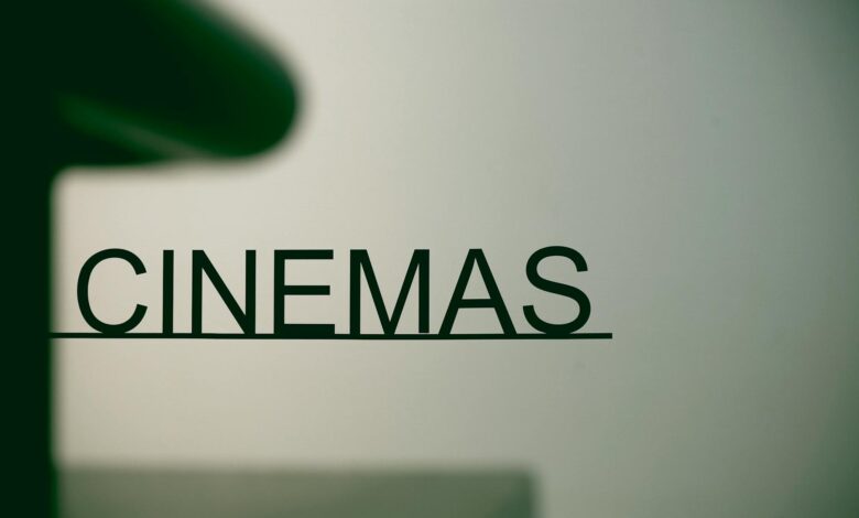 Minimalist cinema sign on pastel background, conveying a contemporary urban vibe.