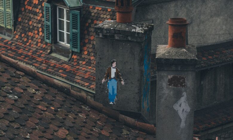 A rustic rooftop featuring unique pixel art graffiti on a chimney in an urban setting.