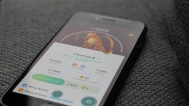 Smartphone displaying Pokémon GO screen with Charizard, highlighting gaming technology.