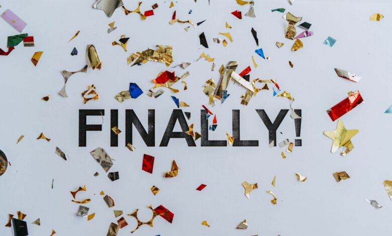 Colorful confetti scattered over the word 'Finally' symbolizing celebration or achievement.