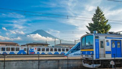 Fujikyu train passing Mt. Fuji on a clear day at Fujinomiya station in Shizuoka, Japan.