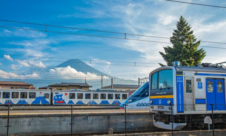 Fujikyu train passing Mt. Fuji on a clear day at Fujinomiya station in Shizuoka, Japan.